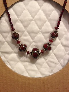 Red lampwork beads with horn, garnet, and silver beads