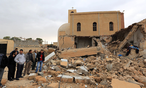Libyans look at the destroyed side room of the Coptic church on December 31, 2012, damaged following an explosion at night in the Mediterranean town of Dafinya, just west of Misrata in which two Egyptians were killed. by Pan-African News Wire File Photos