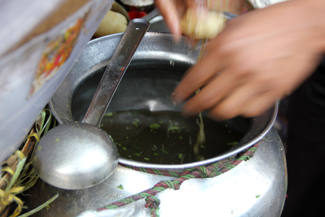 Filling the puri (hollow chip) with tamarind water