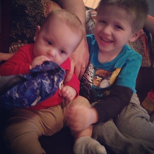 Zachary helped William open a present.