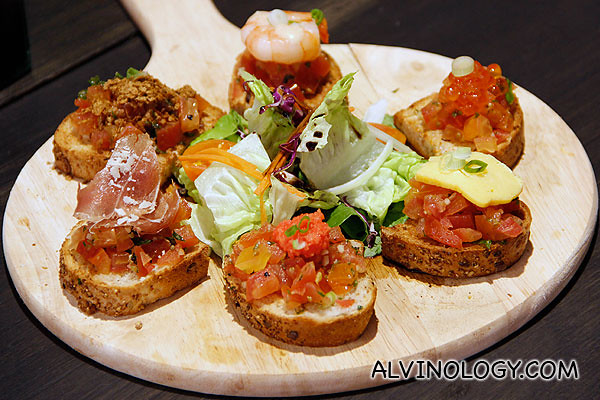 Mixed Crostini - grilled bread topped with Tomato Concasse, Chilled Shrimps, Salmon Roe, Tamagoyaki Egg, and Smoked Salmon (S$18)