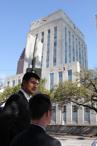 February 15th, 2013 - Yao Ming walks along the streets of downtown Houston and stops at City Hall