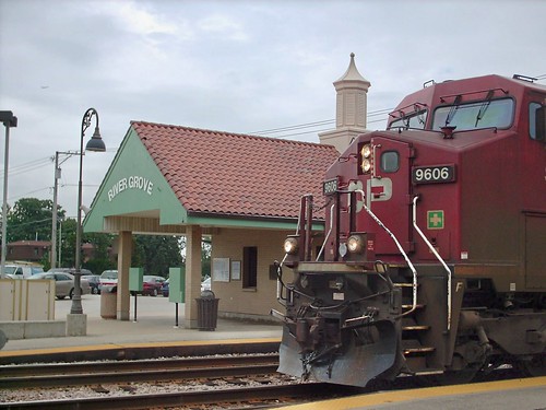 A westbound Canadian Pacific freight train passing through the River Grove Metra commuter rail station.  River Grove Illinois.  August 2007. by Eddie from Chicago