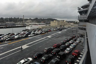 USS Ronald Reagan transports Sailor's cars during a port change.