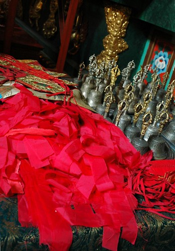 Empowerment tools blessed on the shrine, Hevajra, red blindfolds, crown, dorjes, bells, blue lotus decoration, Sakya Lamdre, Tharlam Monastery of Tibetan Buddhism, Boudha, Kathmandu, Nepal by Wonderlane