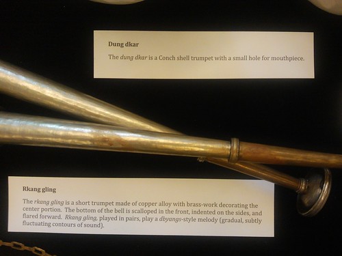 Dung dkar and Rkang gling; dung dkar is a Conch shell trumpet with a small hole for mouthpiece, the rkang gling is a short trumpet made of copper alloy with brass-work decorating the center portion. The bottom of the bell is scalloped in the front. by Wonderlane