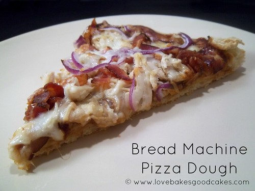 Bread Machine Pizza Dough cooked pizza slice on white plate.