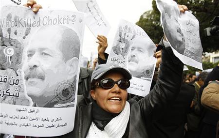 Demonstrators in Tunisia hold posters of Chokri Belaid during nationwide unrest during February 2013. A suspect in the assassination of the opposition figure has been arrested. by Pan-African News Wire File Photos