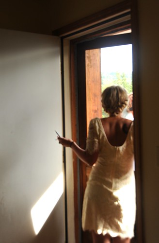 Jessie gets prepared for her wedding, watching guest arrive, wearing her day frock, cabin door, Fairbanks, Alaska, USA by Wonderlane