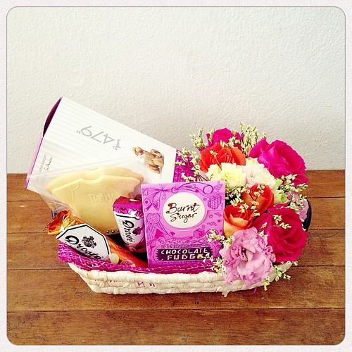One of the gift baskets as requested by @rozaila_z for some special people. Fleur de sel caramel popcorn, chocolate fudge, chocolate pastilles plus flowers in shades of hot pink, purple, orange & yellow. The yummy onesie shaped butter cookie is by @pearlc