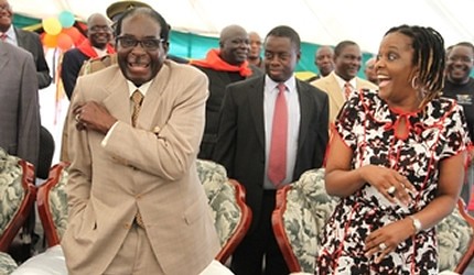 Republic of Zimbabwe President Robert Mugabe with First Lady Amai at a ZANU-PF rally in preparation for the upcoming national elections inside the country. Mugabe is committed to peaceful elections in the Southern African state. by Pan-African News Wire File Photos