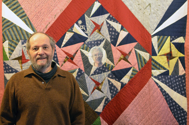 Eli with his father's memorial quilt