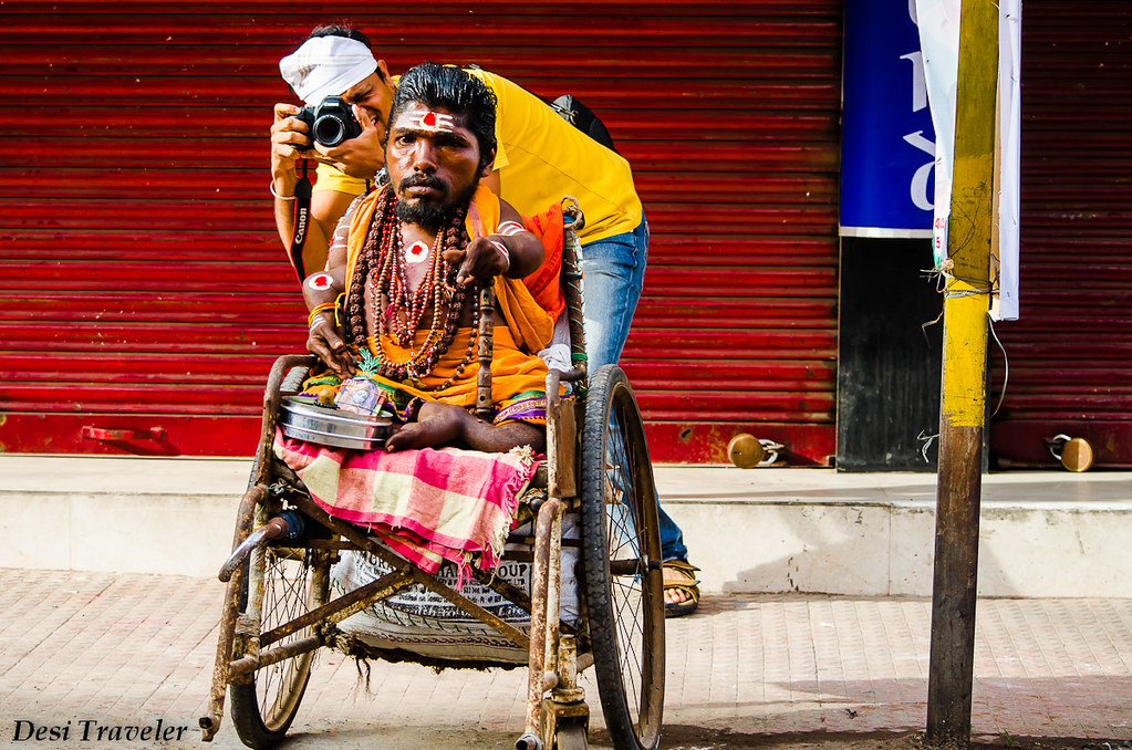 photographer clicking picture with a man in wheelchair