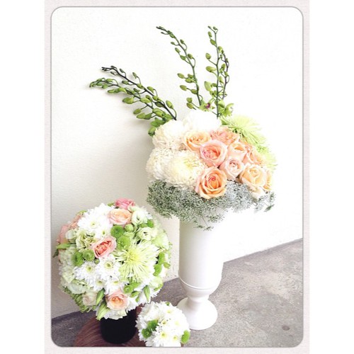 Champagne colored roses, green Eustomas, soft Green Mist, orchids & various Mums.