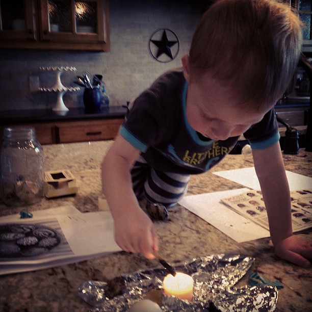 Owen "helping" make Ukrainian eggs. Yes, that's a candle.  Don't worry, mom is close by!