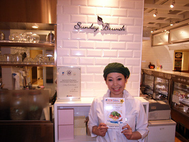 A restaurant manager displays her menu during a recent "Taste of America" promotional event in Tokyo, which was hosted by the Foreign Agricultural Service's (FAS) Agricultural Trade Office (ATO) in Japan. ATO Japan released a smart phone optimized version of their website, us-ato.jp, in conjunction with the promotion. (Courtesy Photo)