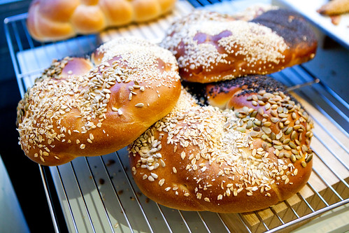 Braided bread loaves rolled in sunflower seeds, sesame and pepitas
