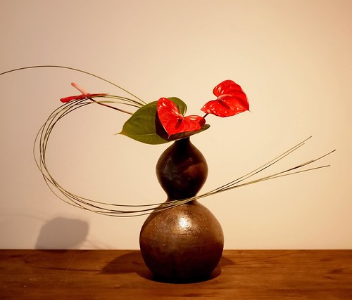 Simple Ikebana Art in a Container on a Wooden Table