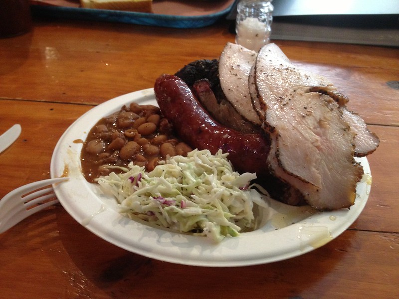 Smoke turkey, smoked sausage, and wet brisket, along with beans and cole slaw from Franklin's BBQ in Austin, Texas