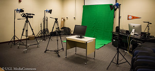 The video production studio has lots of equipment, including a green screen.