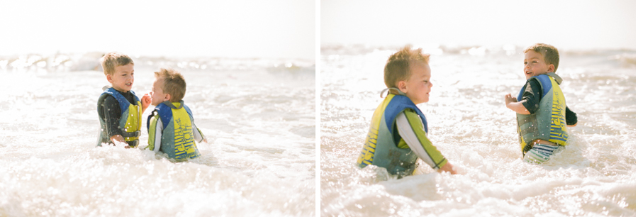 leo and max playing in the waves in galveston