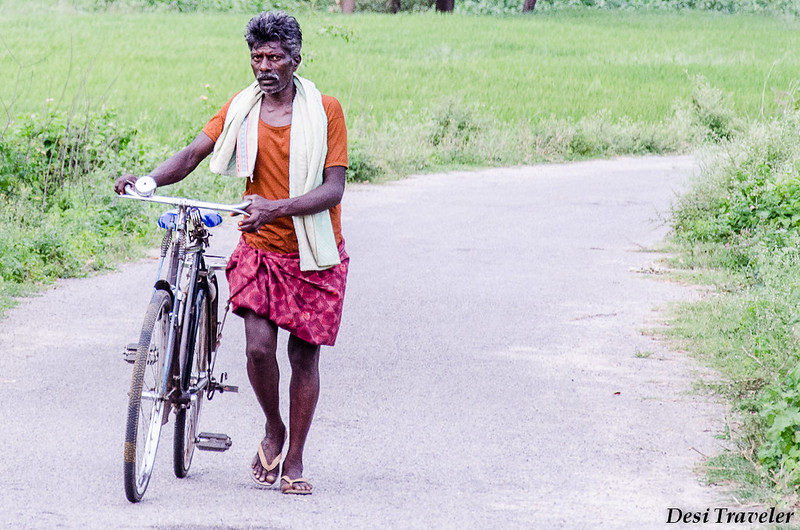 A Cyclist Walking with his Cycle