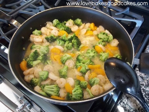 Orange and Broccoli Shrimp cooking in pan on stove. 
