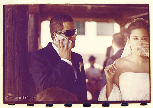 Groom on phone and bride on white wine - Edward Olive European destination wedding photographer