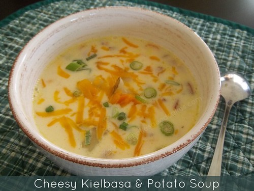 Cheesy Kielbasa & Potato Soup in bowl with spoon.