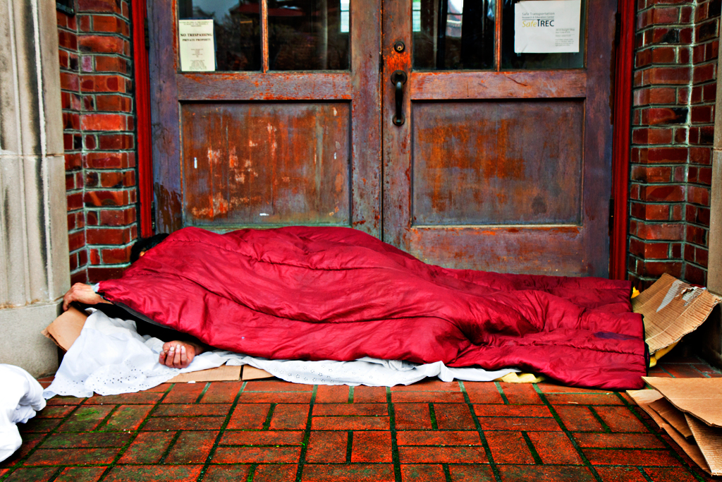 Sleeping-man-outside-wooden-doors-in-3-13--Berkeley