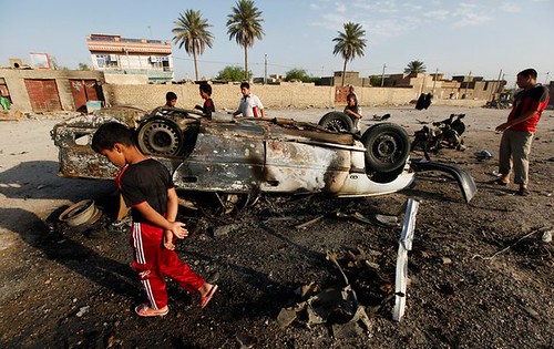 Youth walking around area where car bombs exploded in attacks on Iraq security forces. The security apparatus was established and trained by the United States occupation forces which ostensibly withdrew in six months before. by Pan-African News Wire File Photos