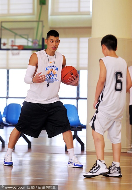 August 19th, 2012 - Jeremy Lin instructsa a basketball camp attendee during the first day of his basketball camp in Dongguan