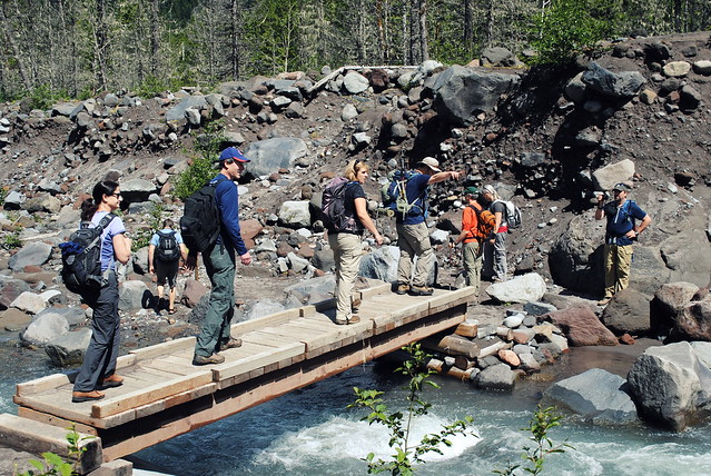 Hikers crossing the seasonal bridge - Ramona Falls Trail - Mt Hood