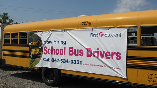 First Student school bus with job recruitment advertising banner.  Glenview Illinois. July 2012. by Eddie from Chicago