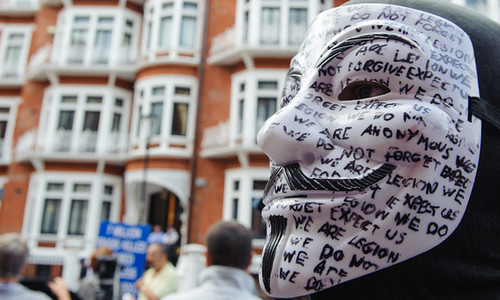 A masked supporter of Julian Assange outside Ecuador's embassy in Knightsbridge, London.