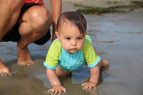Wet baby on the beach