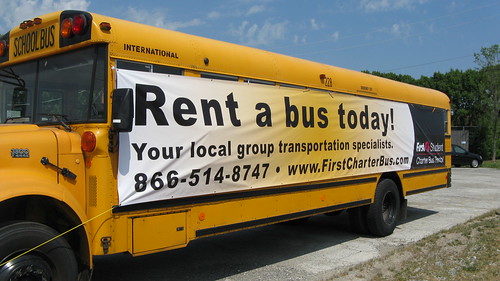 First Student school bus with advertising banner attatched.  Glenview Illinois. July 2012. by Eddie from Chicago