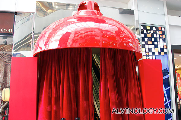 Giant red lampshade at the ground floor entrance inside Central mall