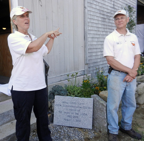 Owners Carole Soule and Bruce Dawson at the Miles Smith Farm – with a commemorative garden plaque marking USDA’s 150th Anniversary.