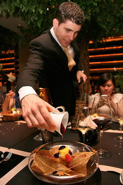 Guillaume pours a decadent sauce onto my dessert
