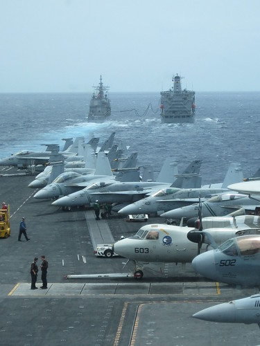 Ships and planes off the coast of Hawaii, participating in the Great Green Fleet demonstration.