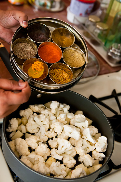 Adding spices from the masala dabba