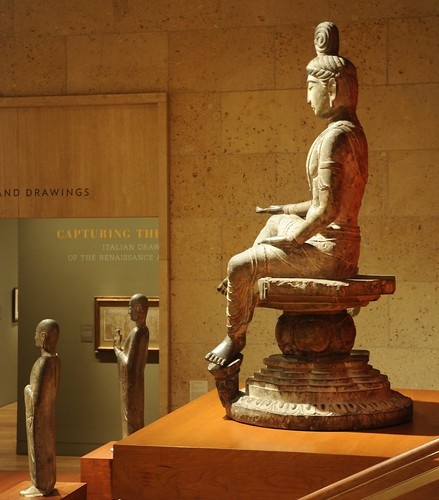 Bodhisattva with open hand, palm up, top knot, seated in posture of royal ease, left foot on a lotus, wearing a mala, flowing garments, mandala seat, statue, 8th Century, Tang Dynasty, Limestone, Art Institute of Chicago, Illinois, USA by Wonderlane