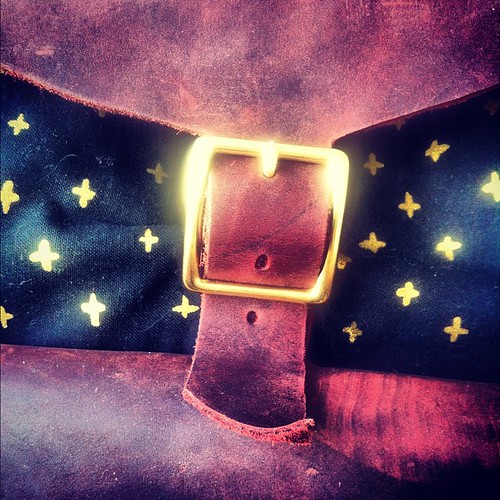 Black print with gold crosses, gold buckle. X-ray Love.