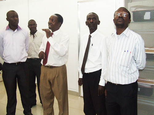 The laboratory technician (in red tie) taking the guests through the facility