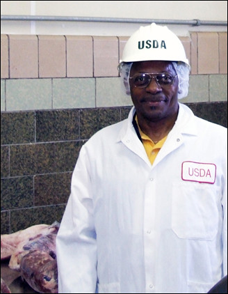 The Rev. Nonnie Holliman is suited up to do his part in keeping the nation’s supply of meat and poultry products safe for consumers.  