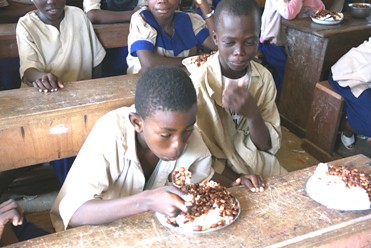 Congolese school children eat lunch provided from USDA-donated agricultural foods as part of a McGovern-Dole Food for Education Program. The program provides meals to children in low-income, food-deficit countries – such as the Republic of Congo – that are committed to universal education. The program aligns with President Obama’s Feed the Future initiative and has helped feed millions of children over the years. 