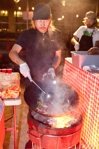 Chef/Owner Danny Bowien of Mission Chinese stir frying with his wok on a portable gas grill