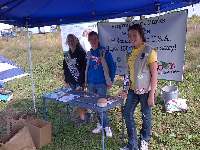 Girl Scouts teach fair goers about trail signs using natural materials