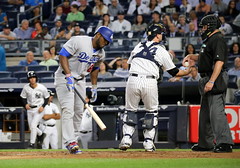 The Dodgers' Yasiel Puig writhes in pain after fouling off a pitch in the first inning.